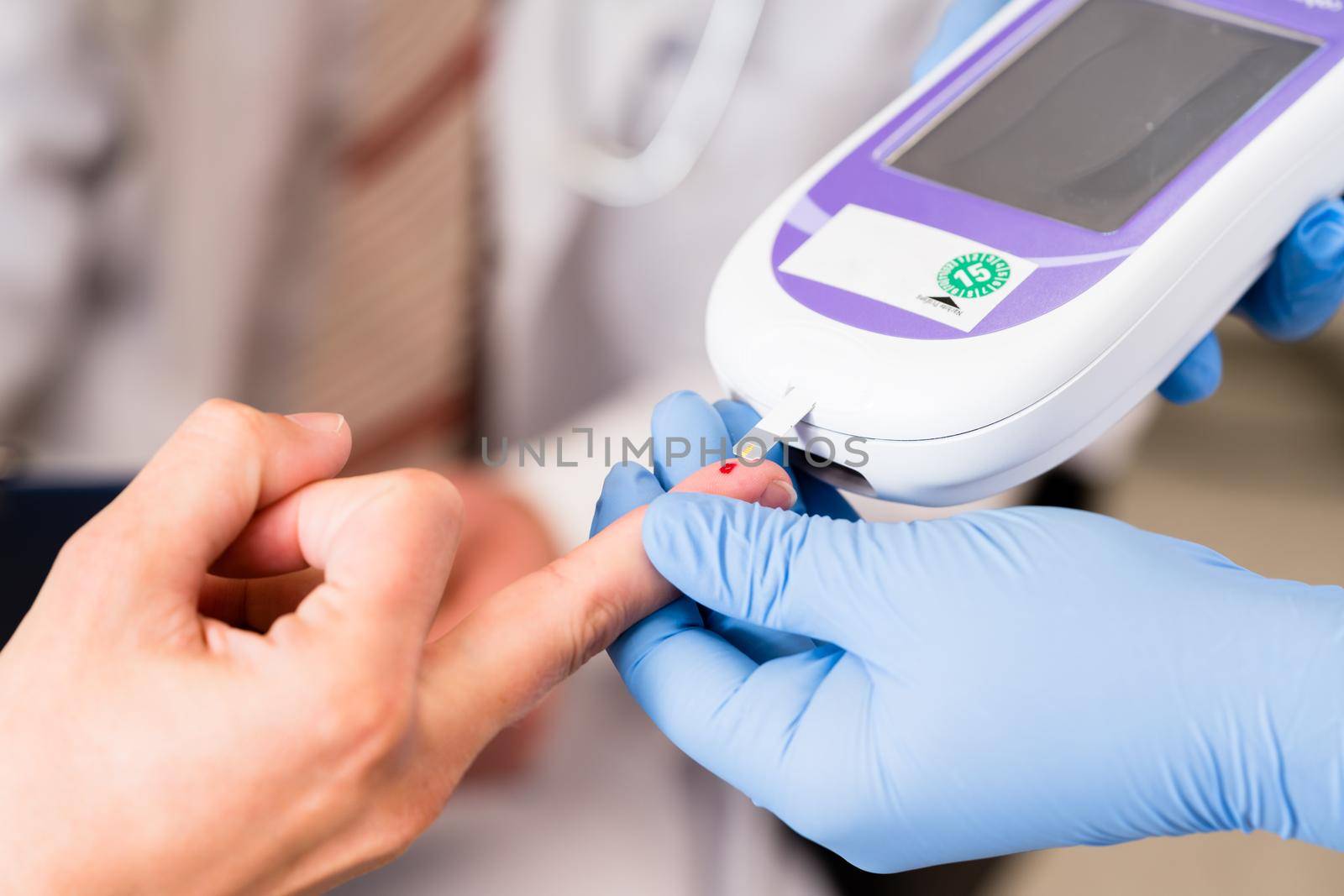 Diabetes test with strip measure in doctors office by Kzenon
