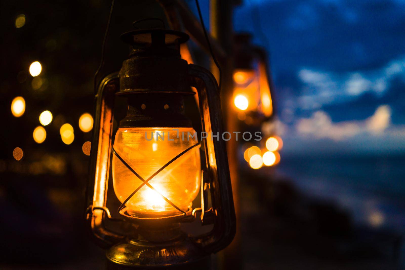 Sunset on an island beach with lanterns illuminating the romantic scene
