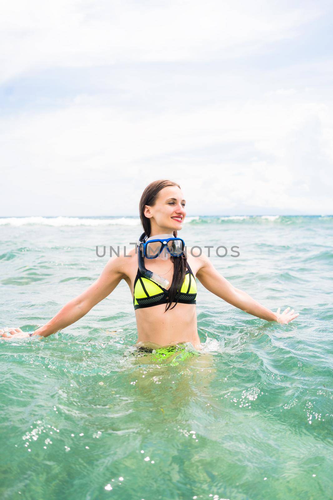 Girl with diving goggles in sea having summer vacation by Kzenon