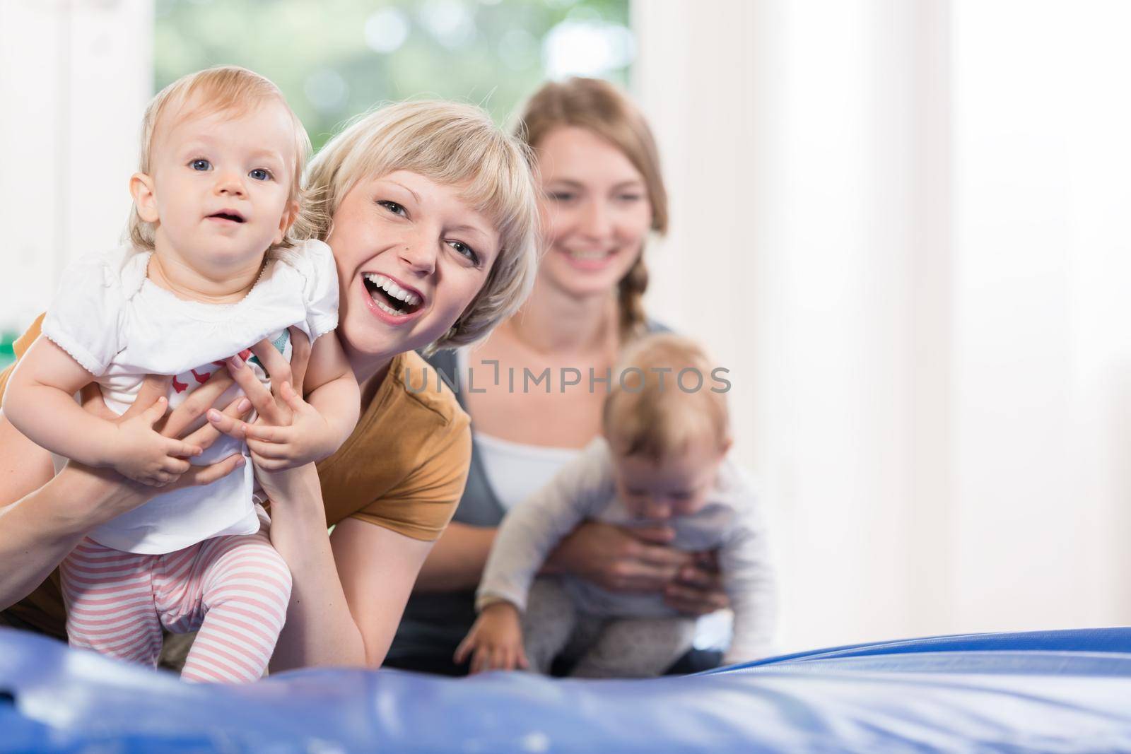 Young moms and their little children in mother and child course by Kzenon
