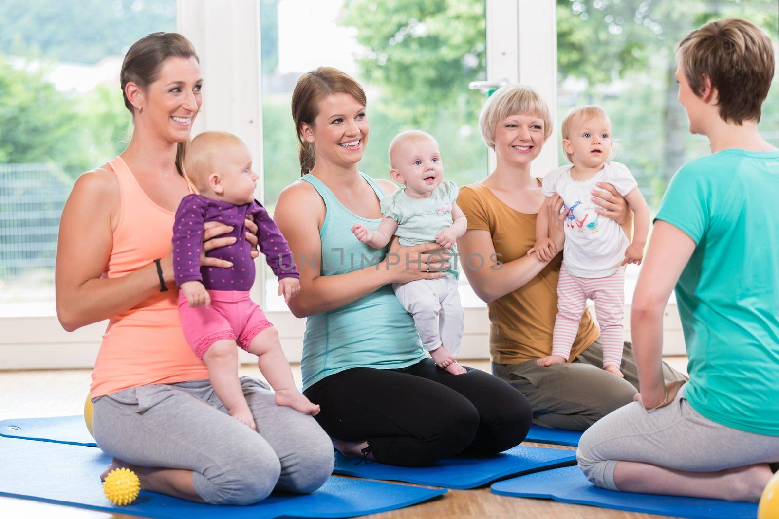 Women and their babies in mother-child gymnastic course by Kzenon