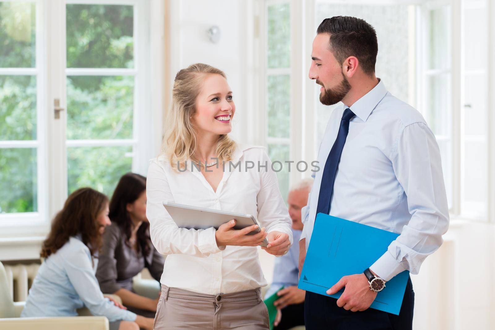 Business people in office having informal meeting and short presentation