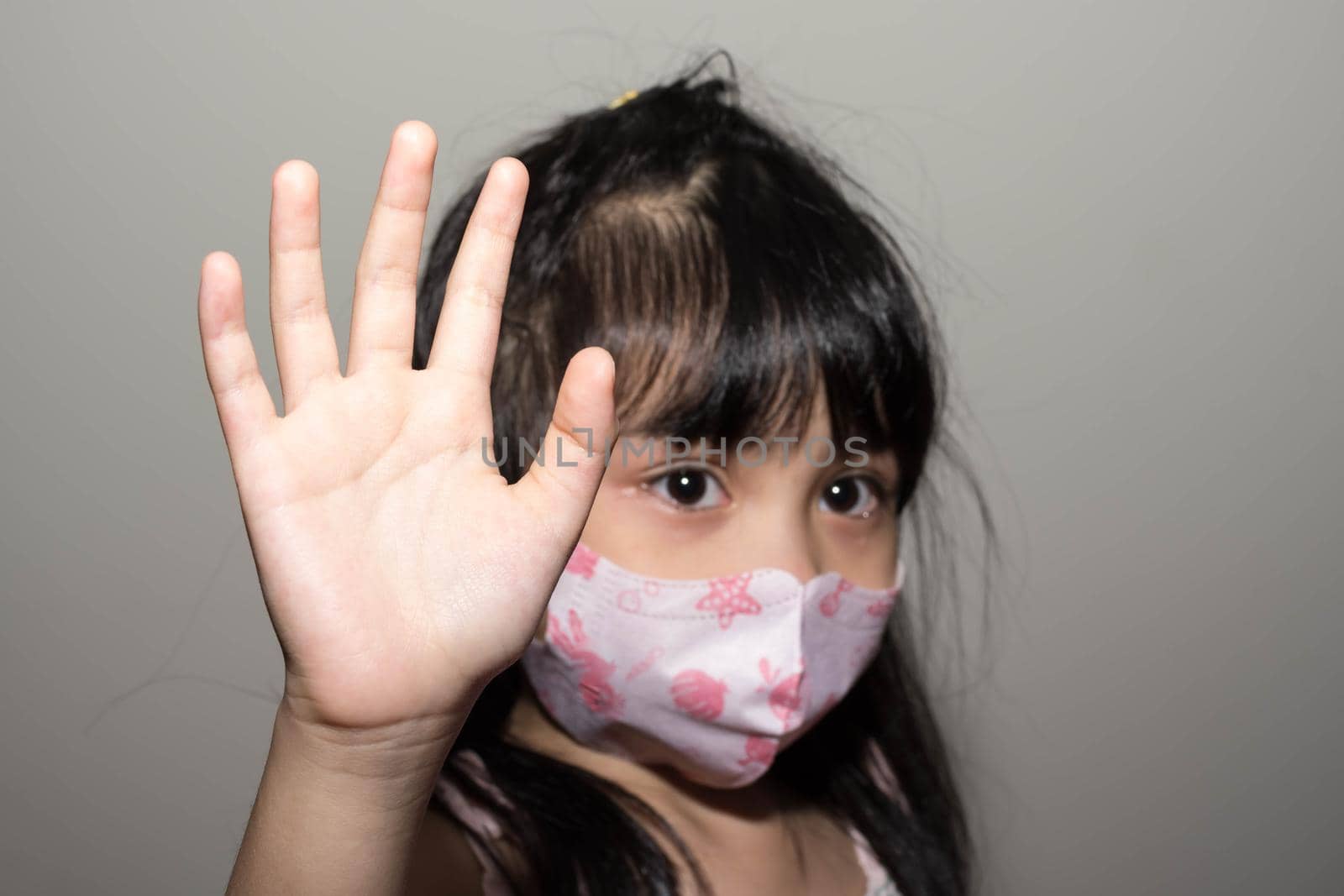 Kids hand to say no against corona virus infection. Blurry image of a female kid showing her hand to symbolize against the spread of corona virus