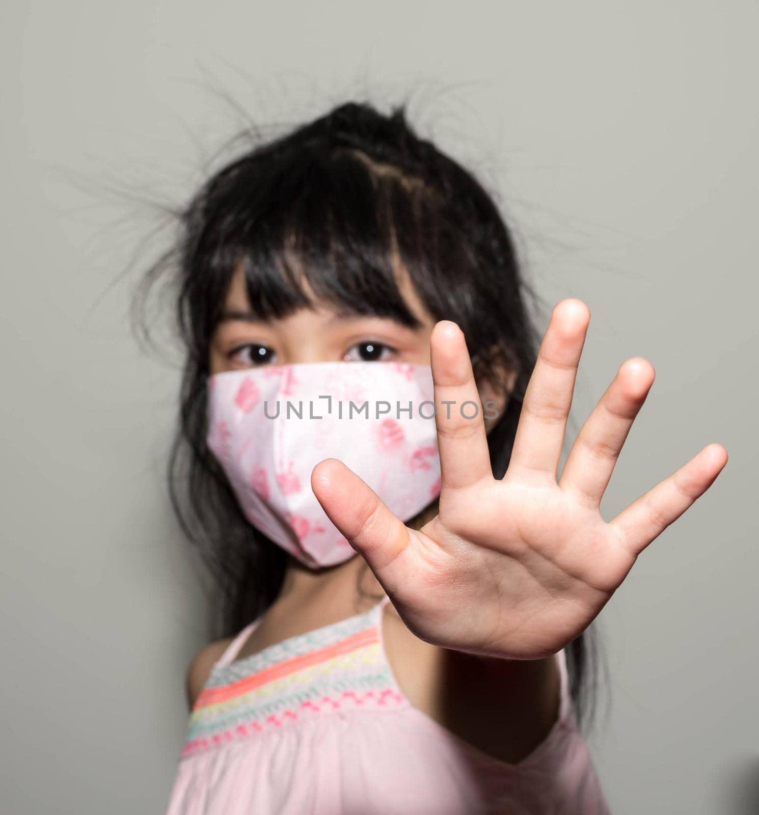 Kids hand to say no against corona virus infection. Blurry image of a female kid showing her hand to symbolize against the spread of corona virus