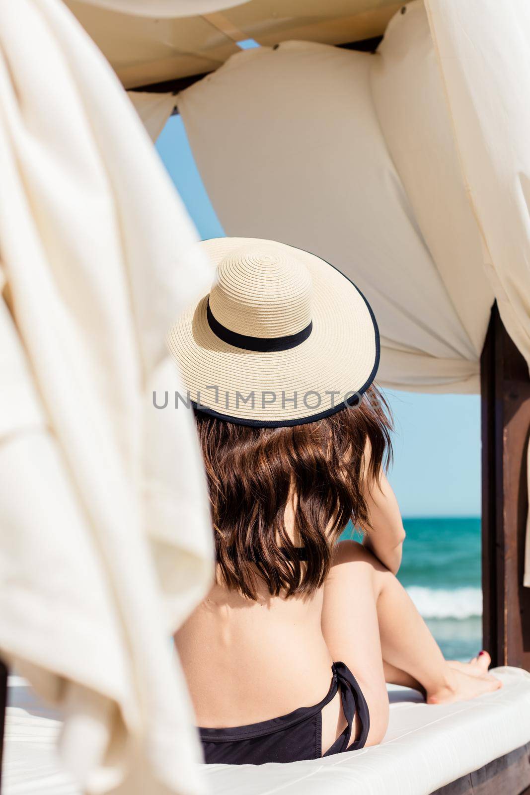 Woman on the beach in sun tent by Kzenon