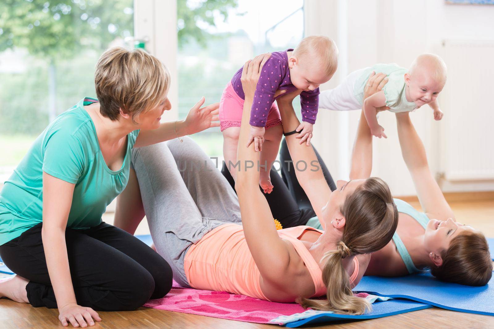 Women and their babies in mother-child gymnastic course by Kzenon