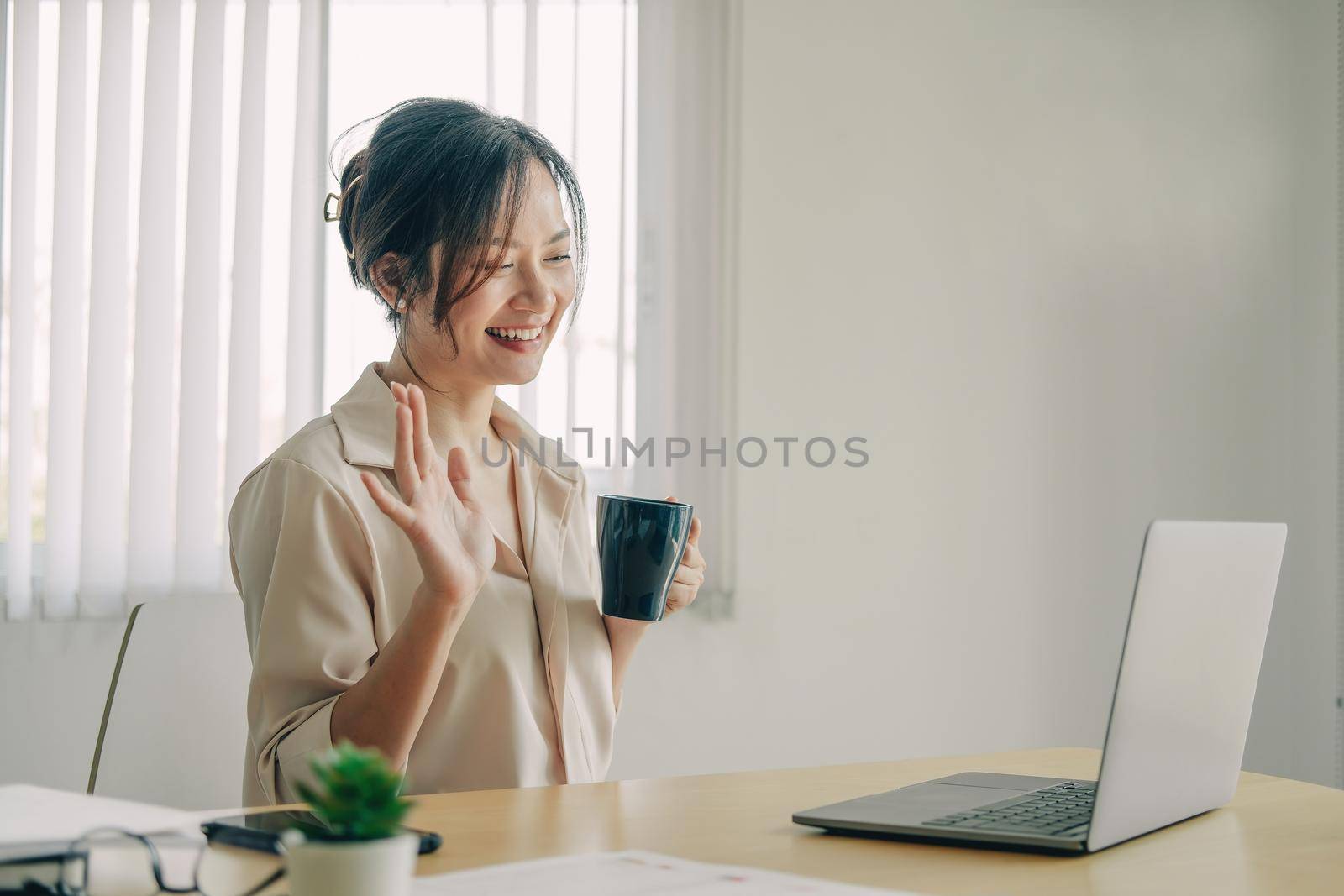 Attractive asian woman having video call via laptop at home office, Consultation, webinar, tutoring on internet, telecommuting concept by nateemee
