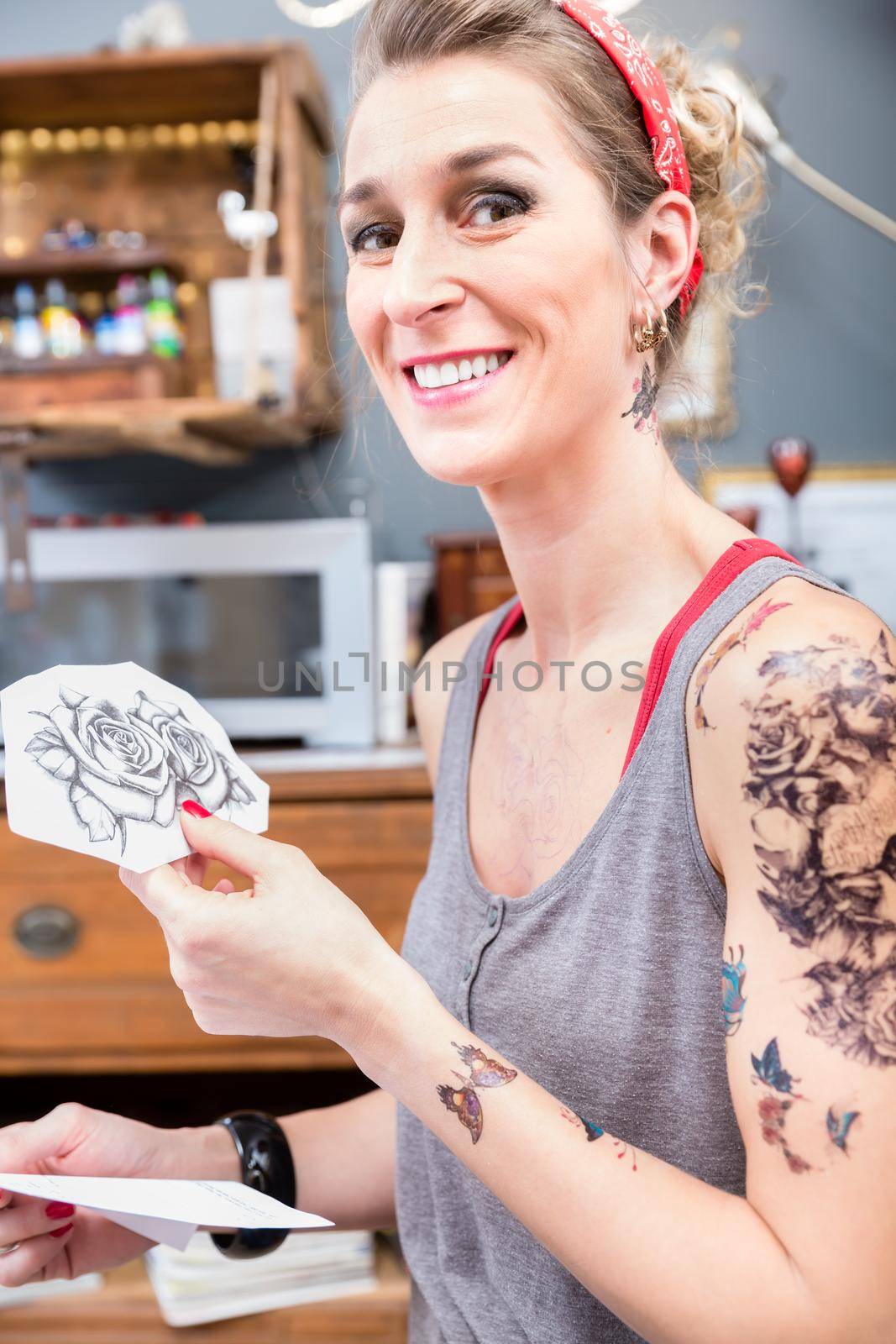 Portrait of a fashionable woman happy for choosing two roses for her new tattoo by Kzenon