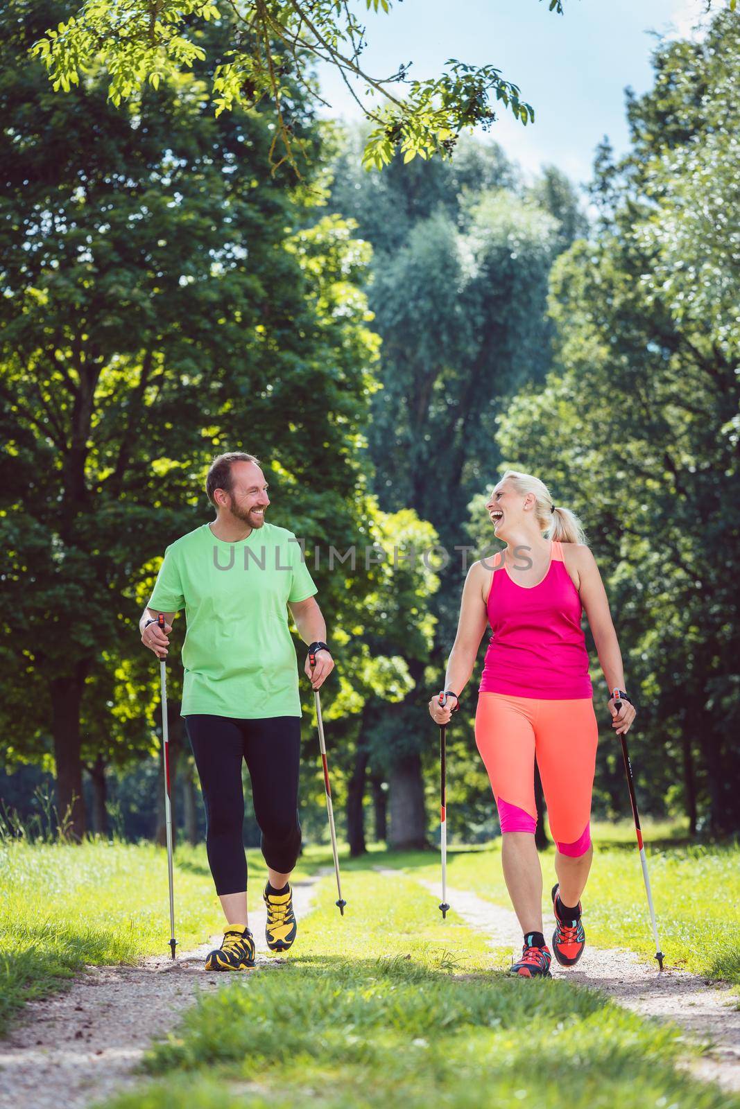 Couple of man and woman doing Nordic Walking for sport