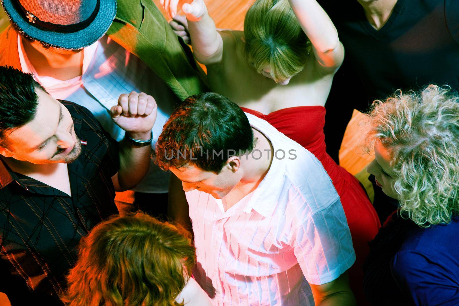 Crowd of people dancing in a disco club having a great party