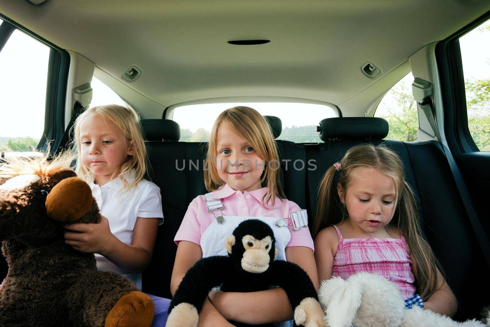 Family with three kids in a car