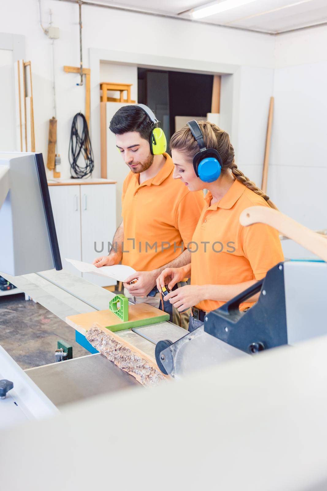 Carpenter programming computer controlled saw, a CNC machine