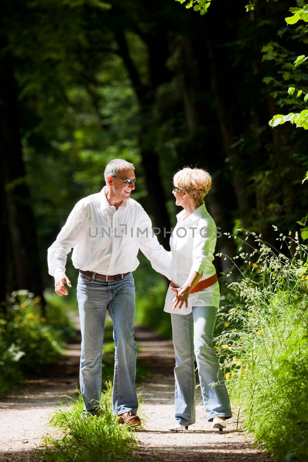 Happy mature couple outdoors by Kzenon