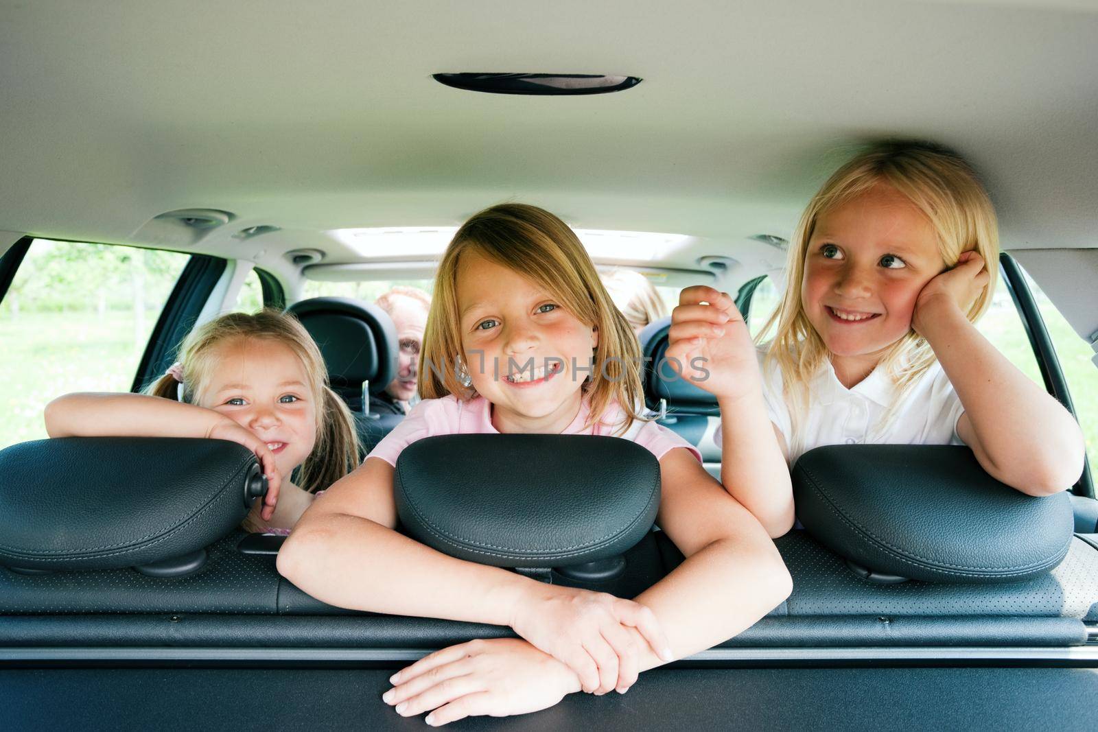 Family with three kids in a car