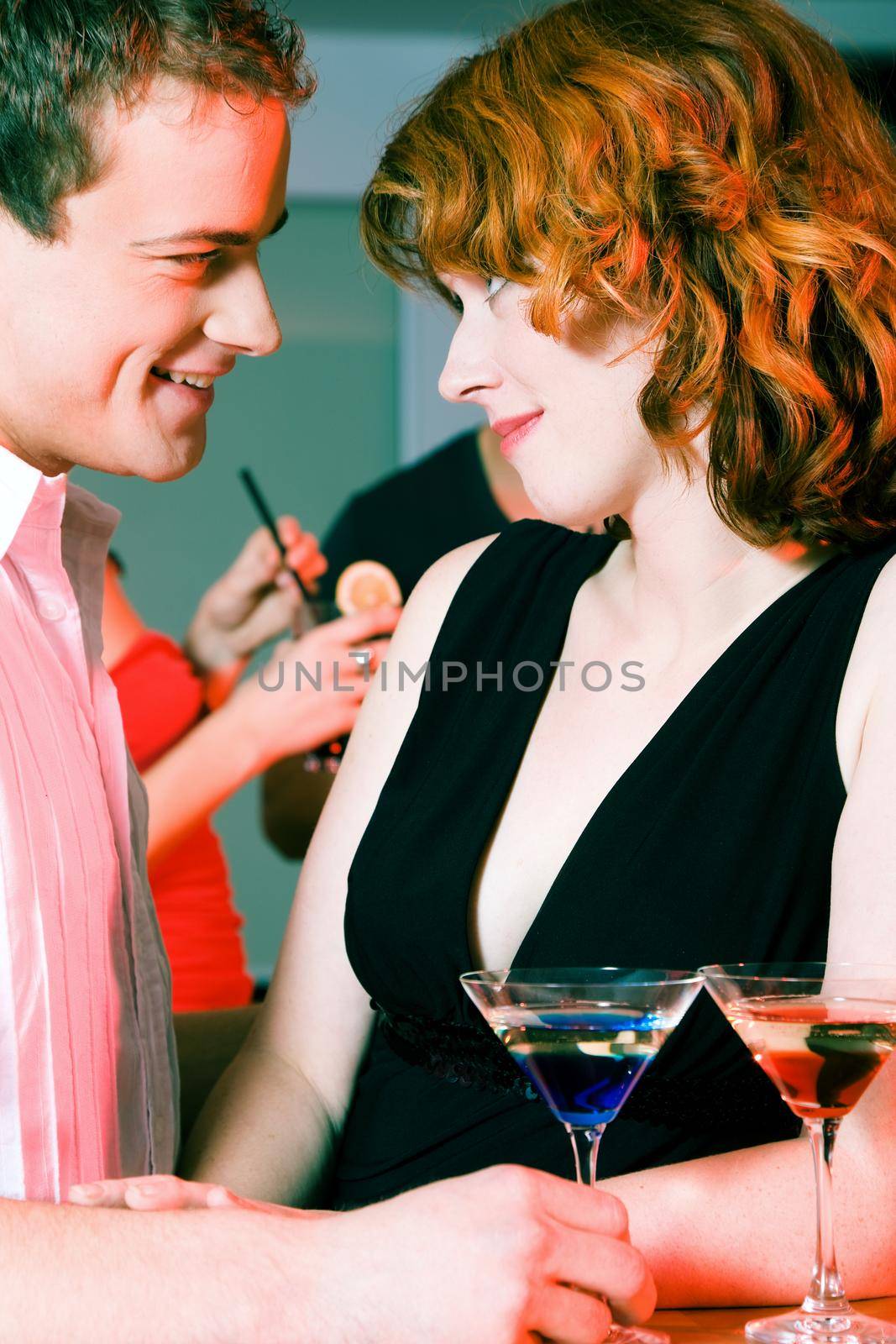 Couple flirting at a party by Kzenon