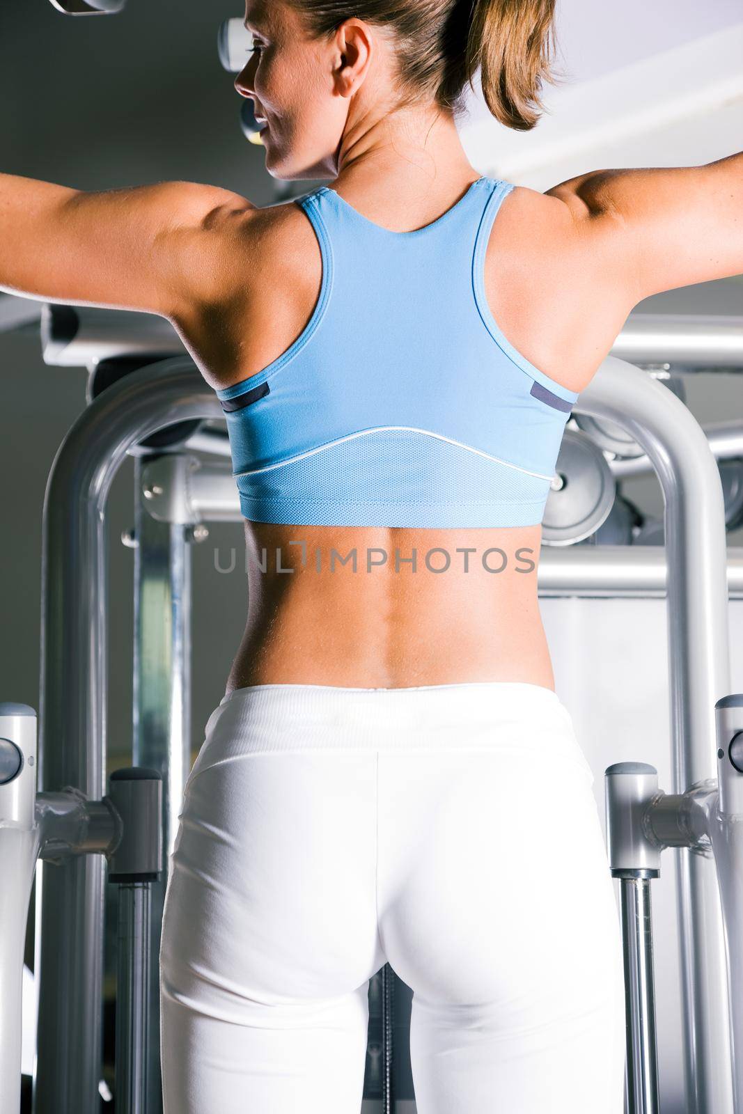 Woman working out in gym by Kzenon