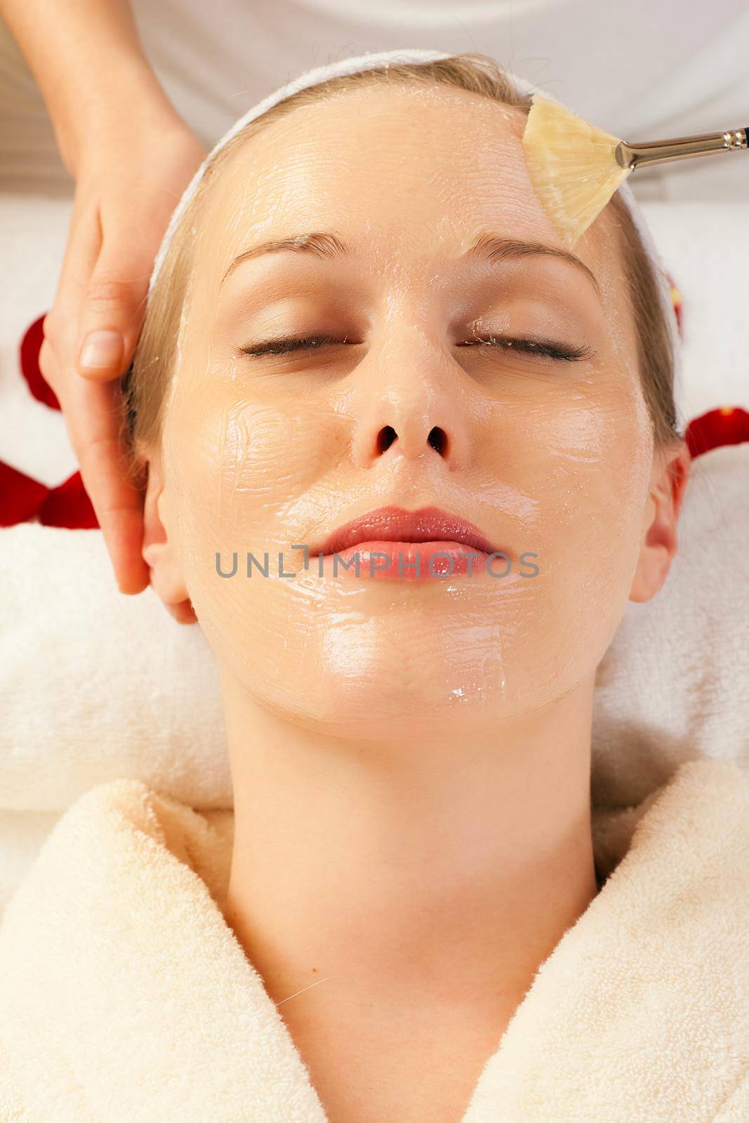 Woman having a mask or cream applied in the course of a beauty treatment