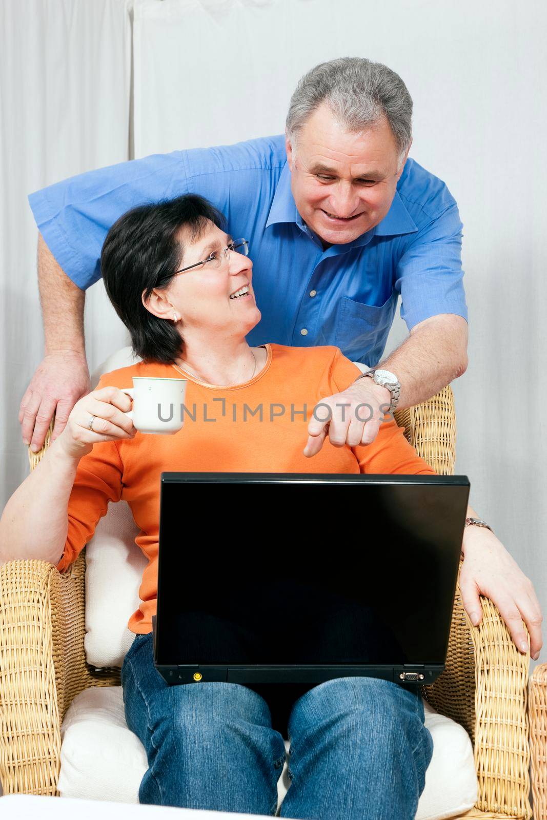 Senior couple surfing the internet using a laptop computer