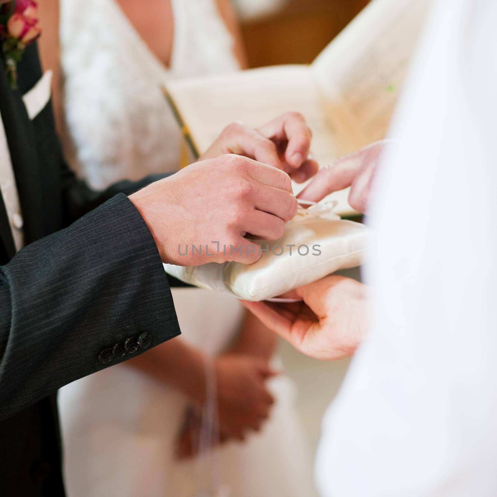 Groom taking rings in wedding ceremony by Kzenon