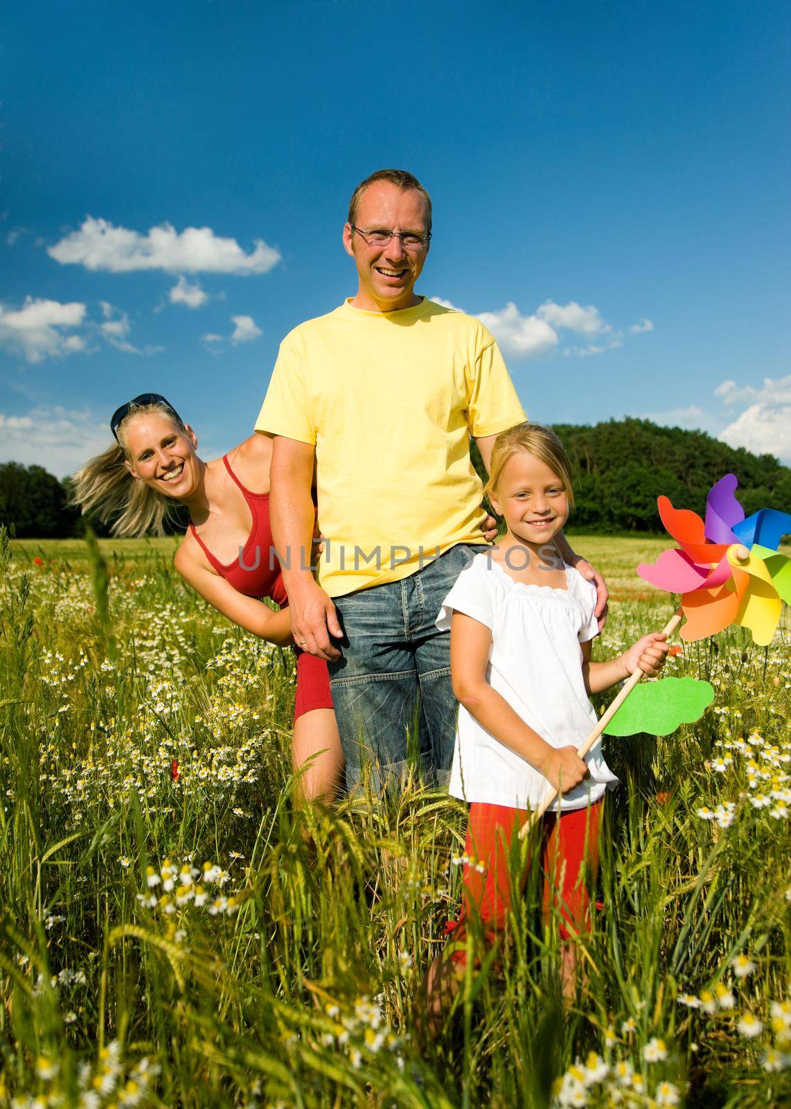 Family in the grass at a wonderful summer day