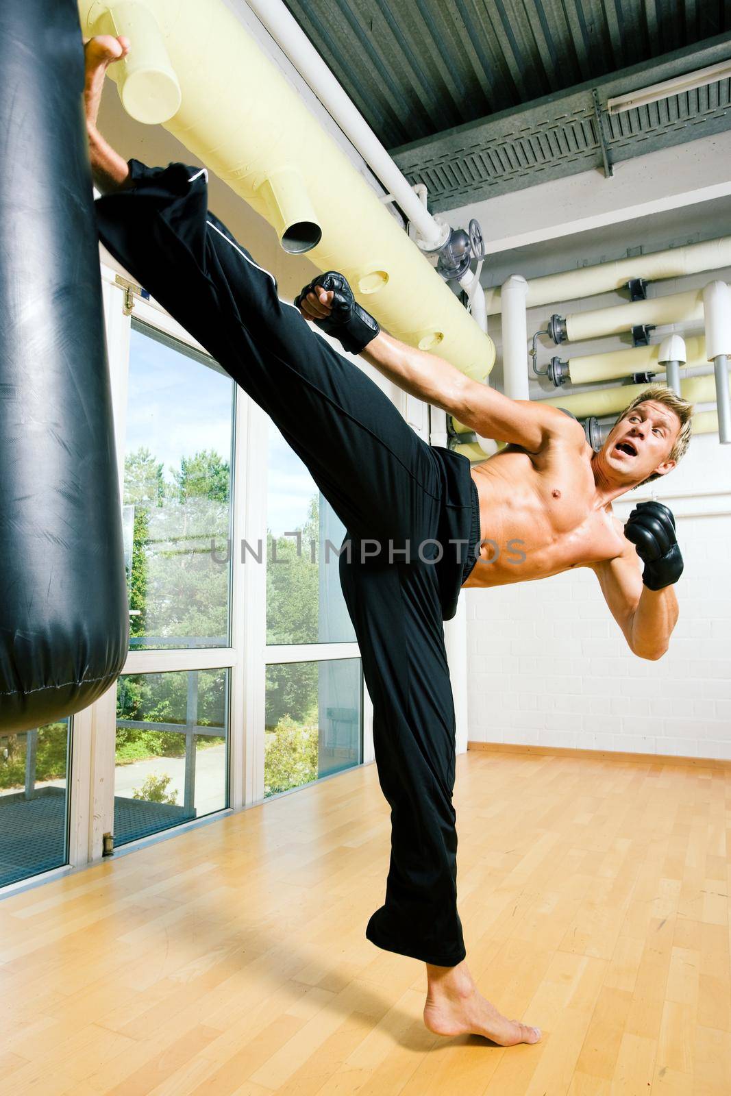 Kickboxer kicking the sandbag