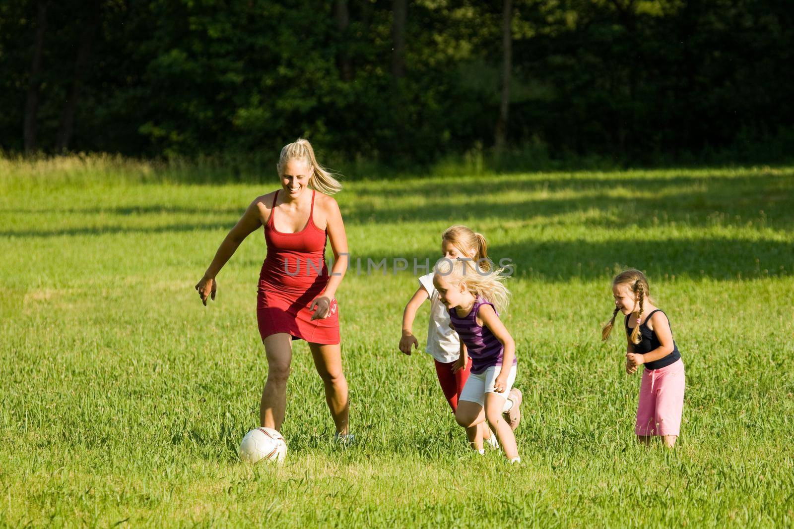Family playing soccer by Kzenon