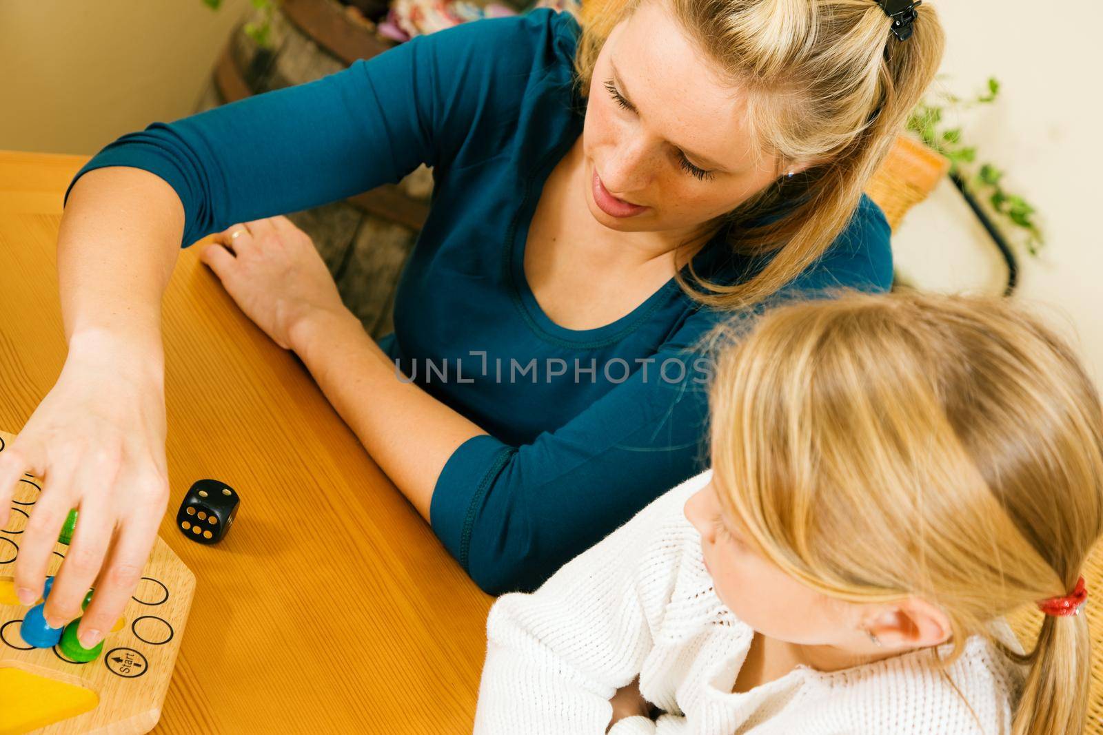 Family playing a board game together having a lot of fun