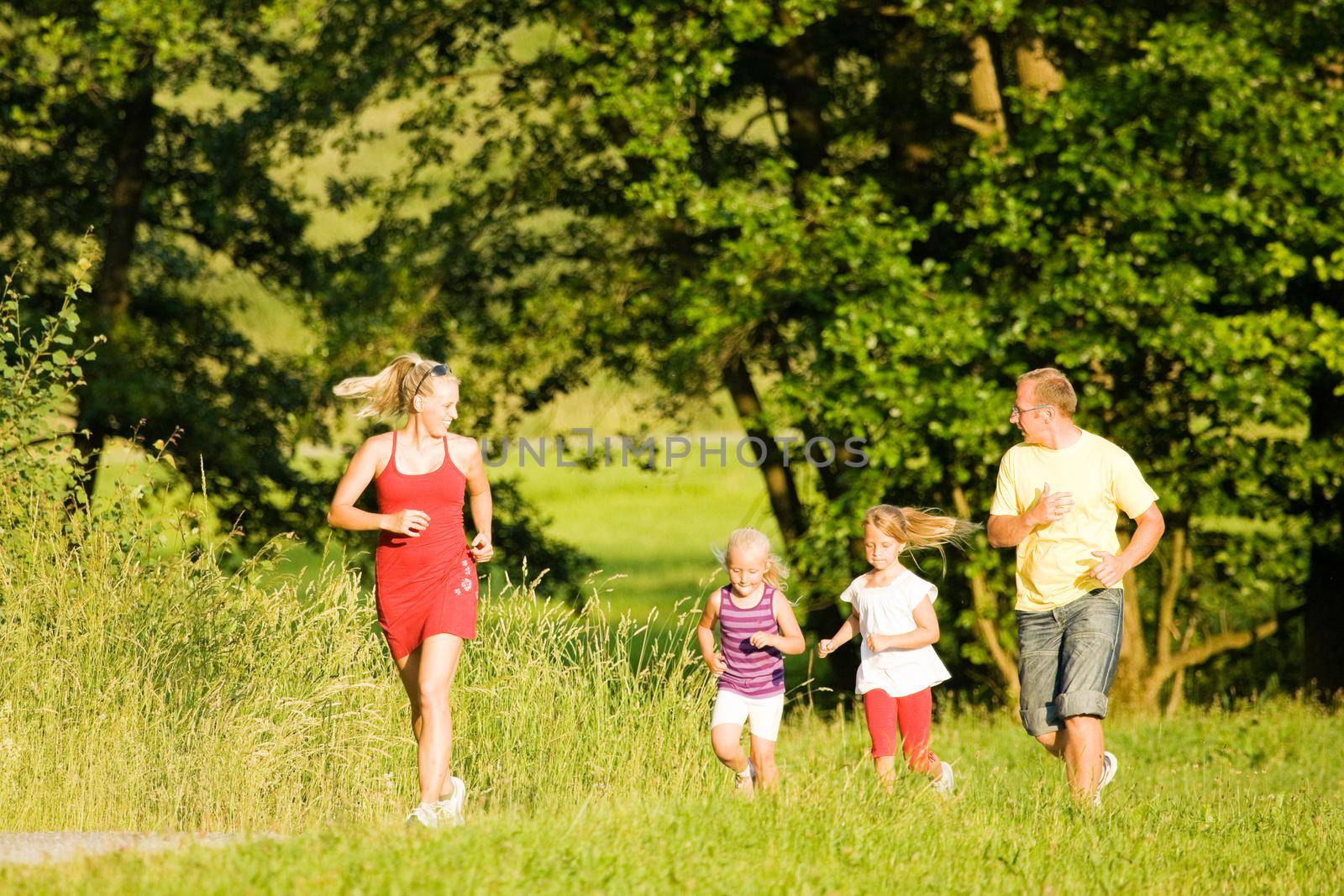 Family jogging with two little daughters