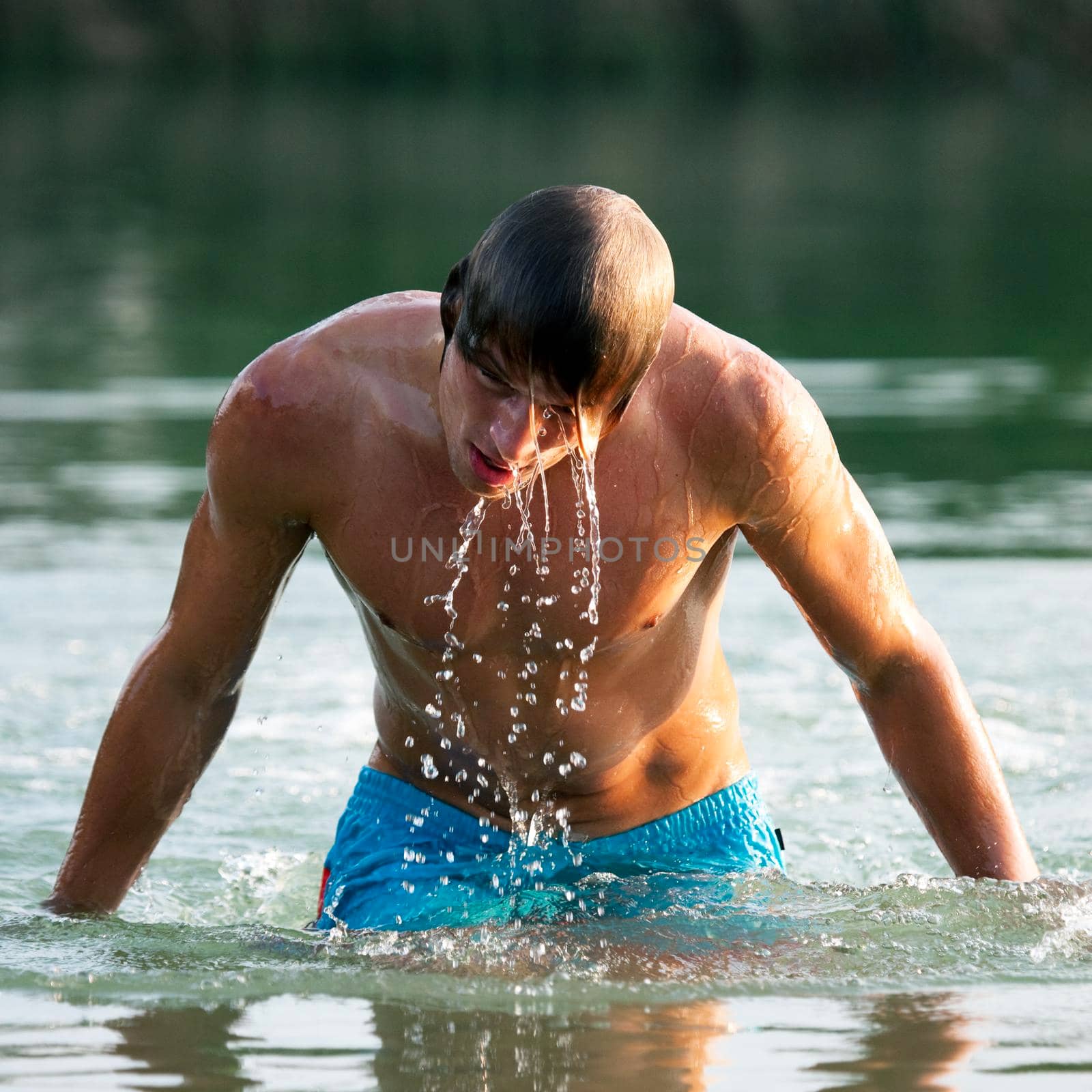 Swimmer getting out of water by Kzenon