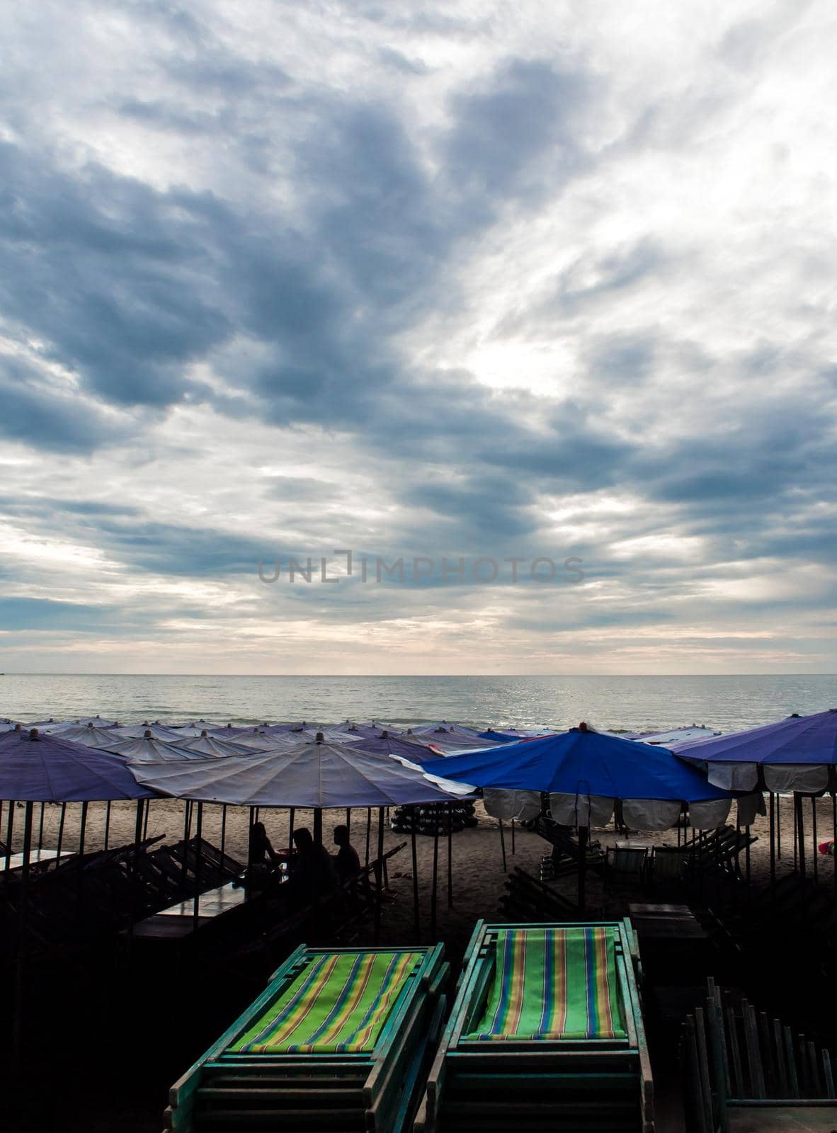 Colorful canvas daybed under the beach umbrella