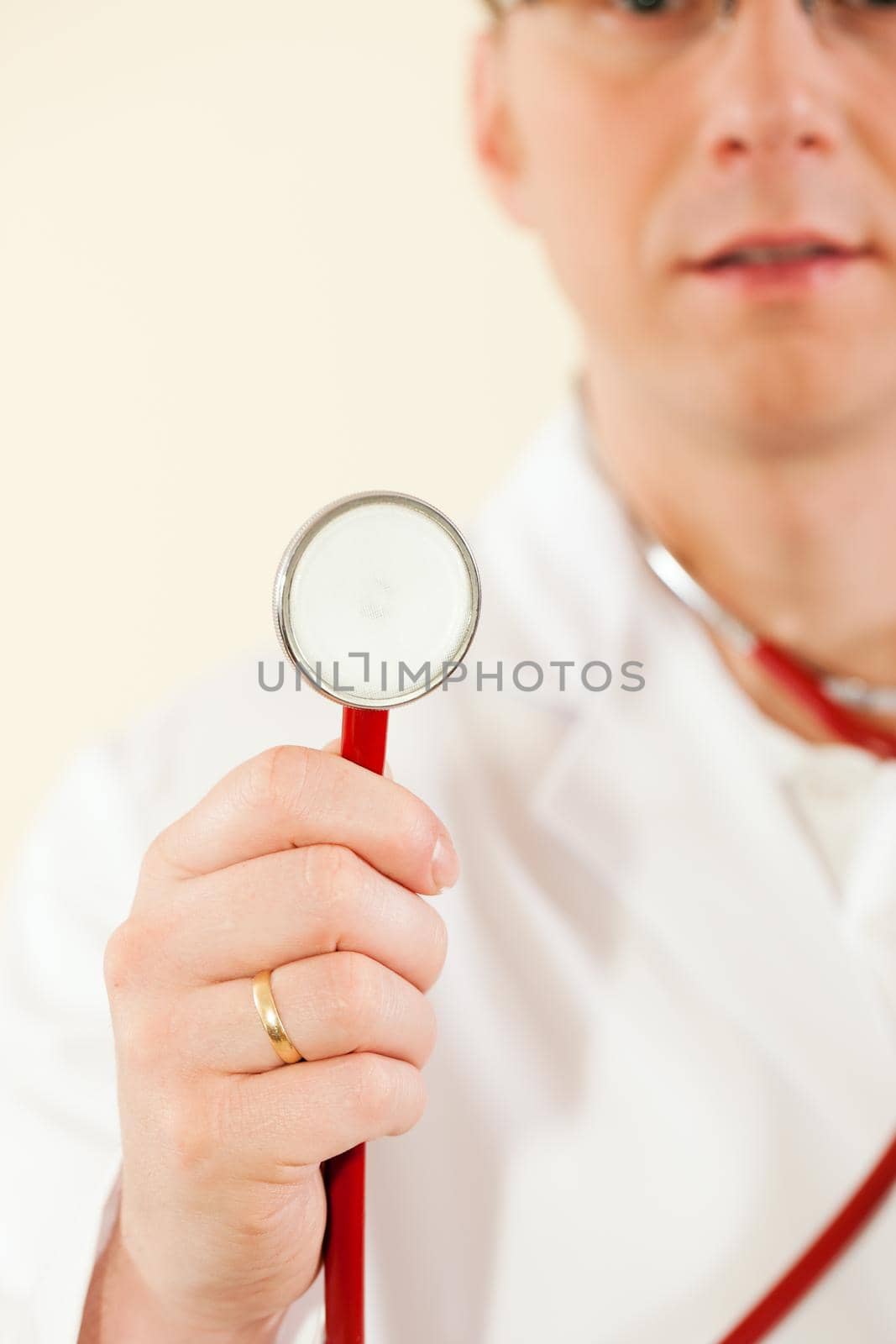 Medical doctor with stethoscope, focus is on the worktool
