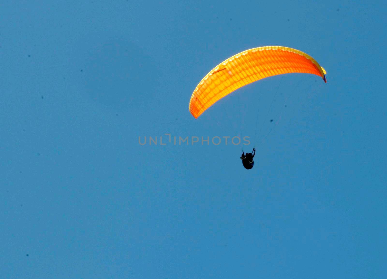 porto seguro, bahia / brazil - february 7, 2008: Paragliding pilot is seen during flight at Taipe beach in the Trancoso district of Porto Seguro.