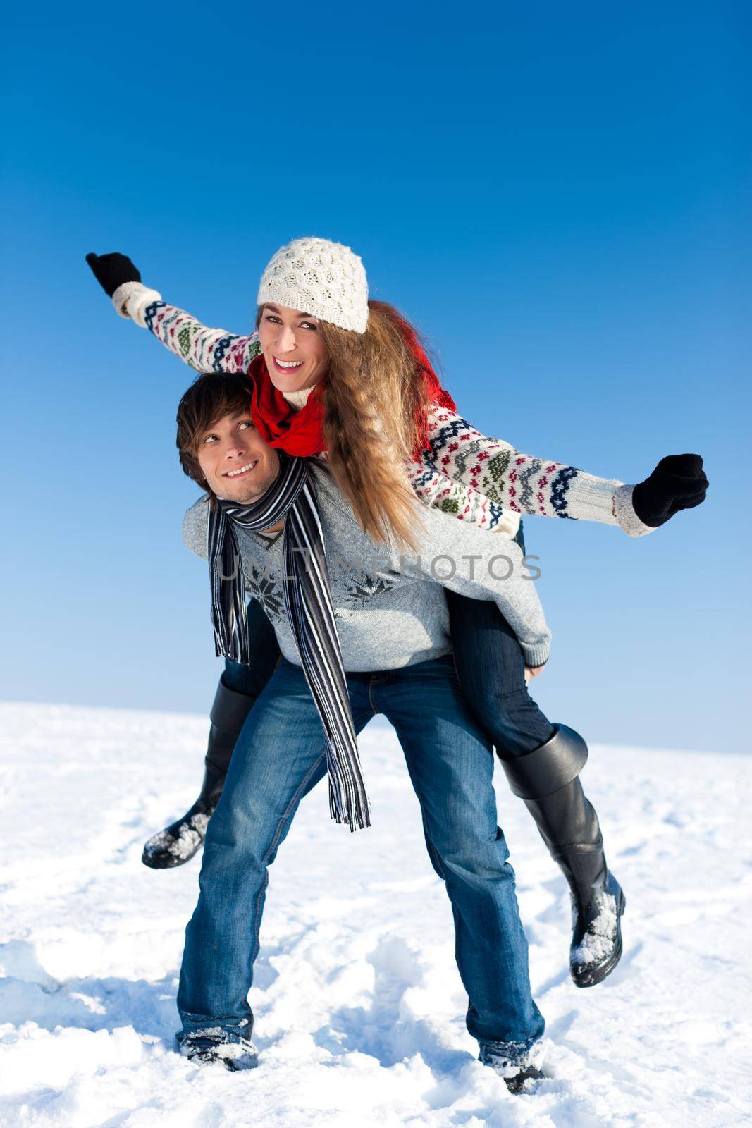 Couple - man and woman - having a winter walk embracing each other