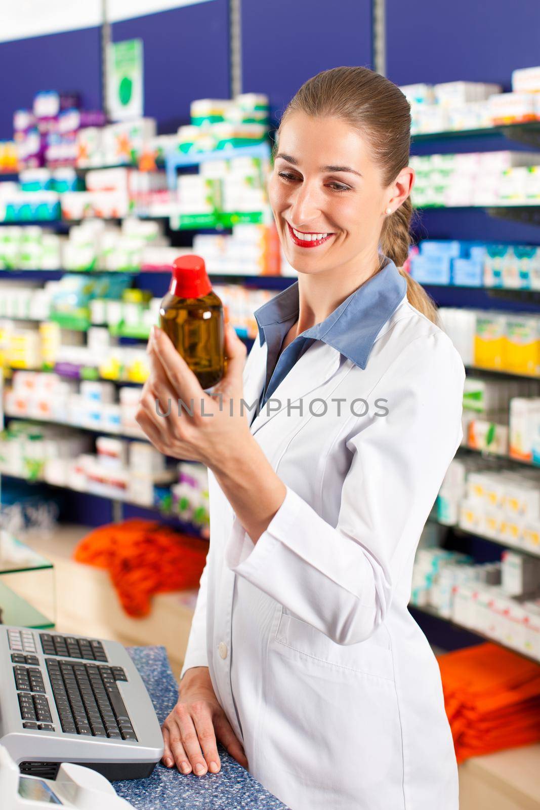Female pharmacist in her pharmacy by Kzenon