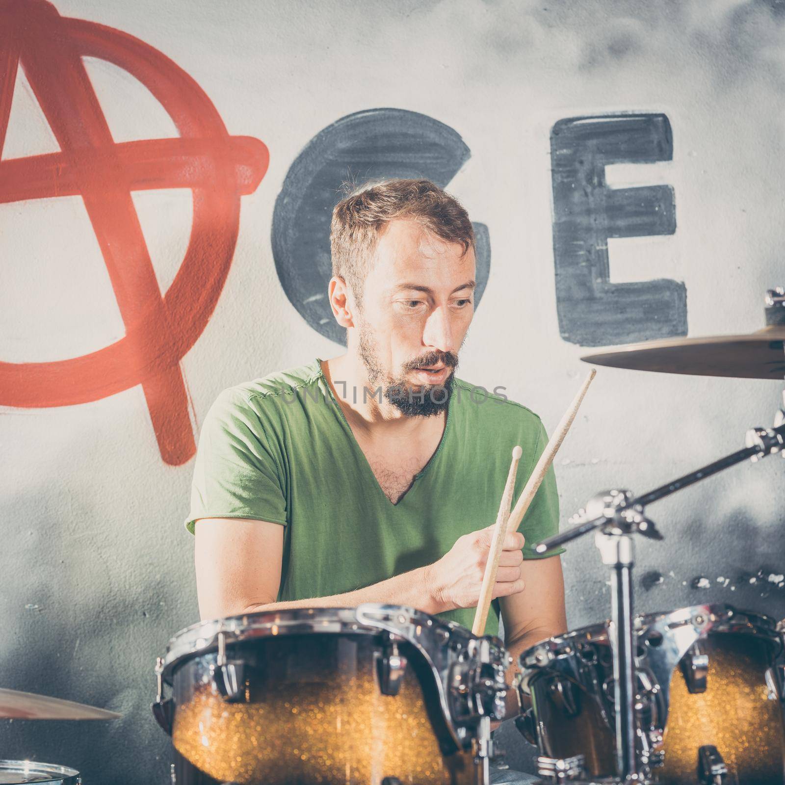 Musician playing the drums on stage in rehearsal room