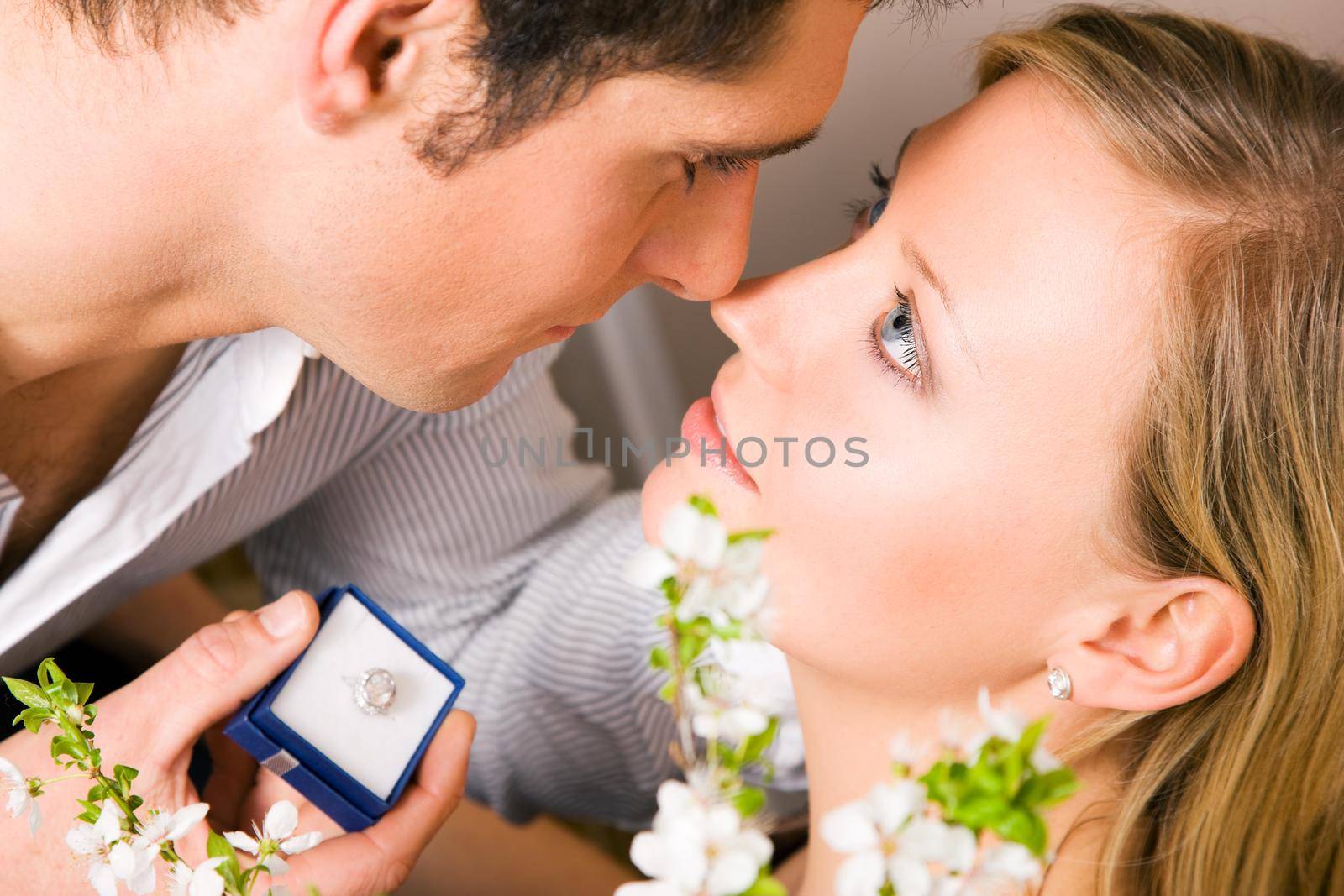 He is proposing, she looks as if she is considering a yes; focus on eyes