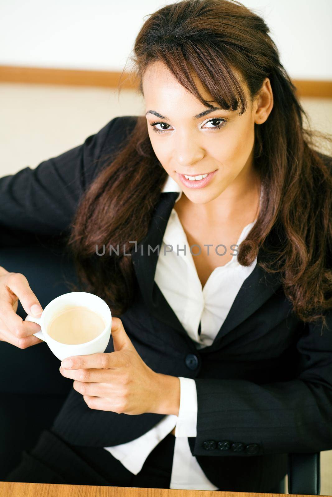 woman at her workplace having a double espresso
