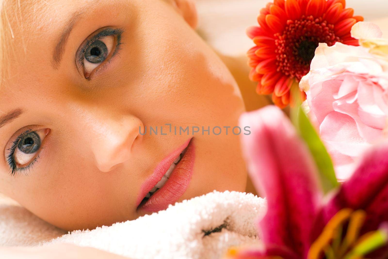 Girl with flowers in a spa situation feeling visibly good