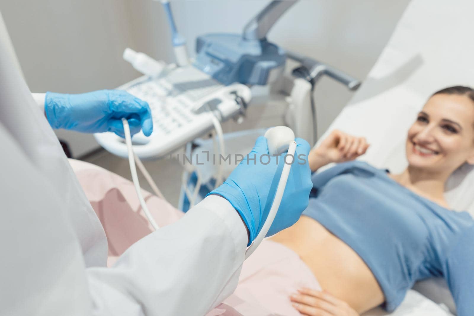 Gynecologist attempting ultrasonic examination of patient woman