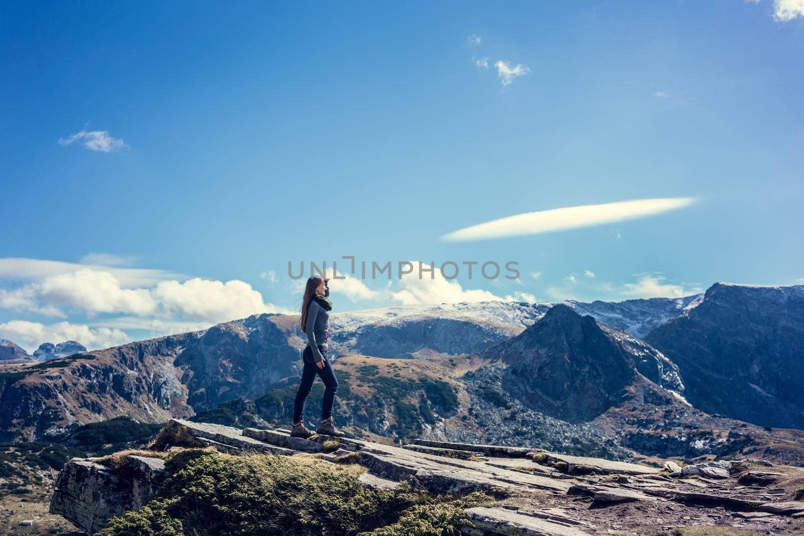 Woman admiring the view hiking the rila mountains