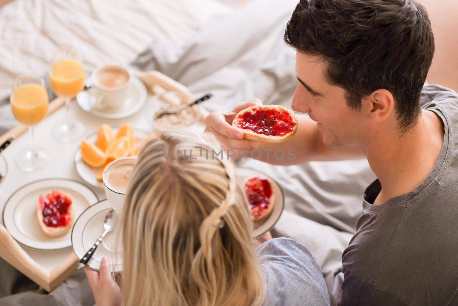 Husband and wife sharing a relaxing breakfast by Kzenon