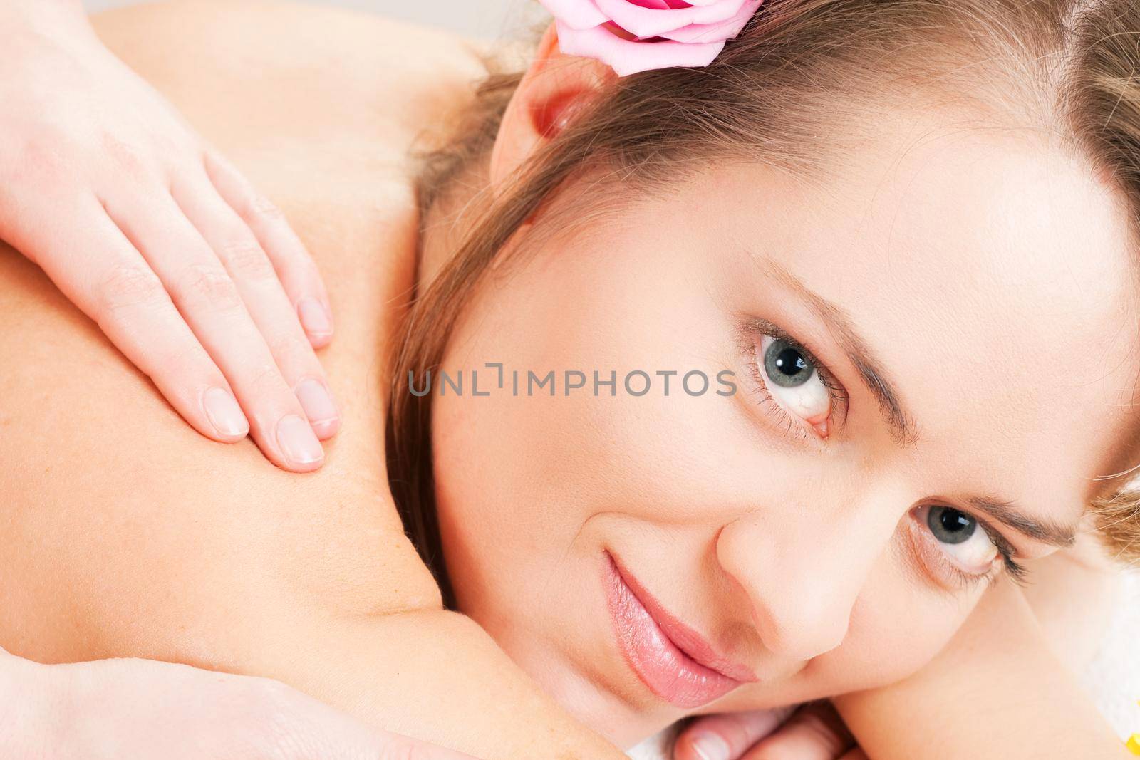 Beautiful woman having a wellness back massage and feeling visibly good about it