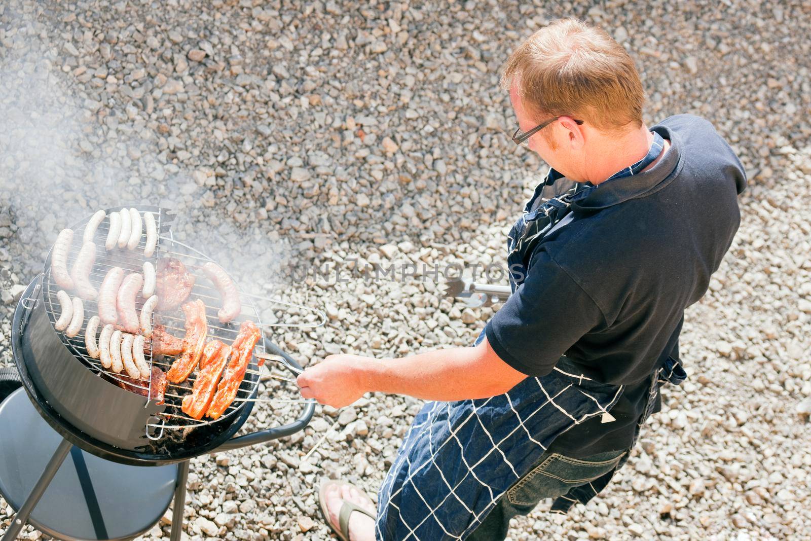 Man at the barbecue grill by Kzenon
