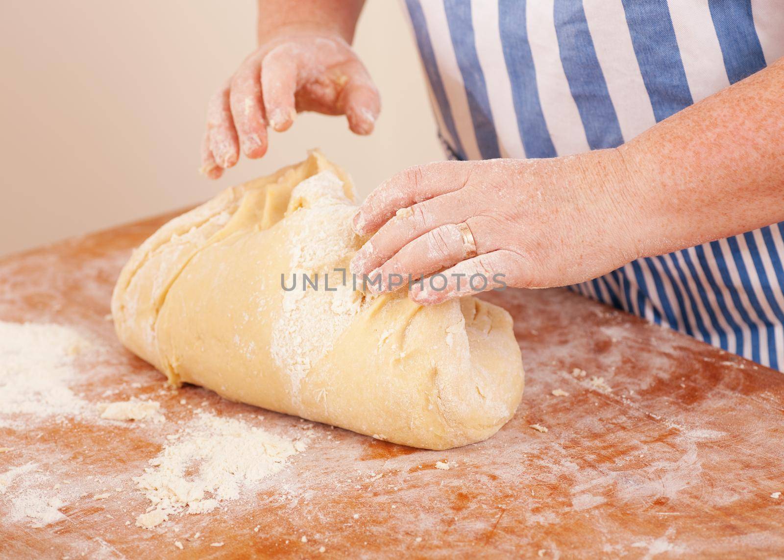 Baking biscuits, woman kneading the dough