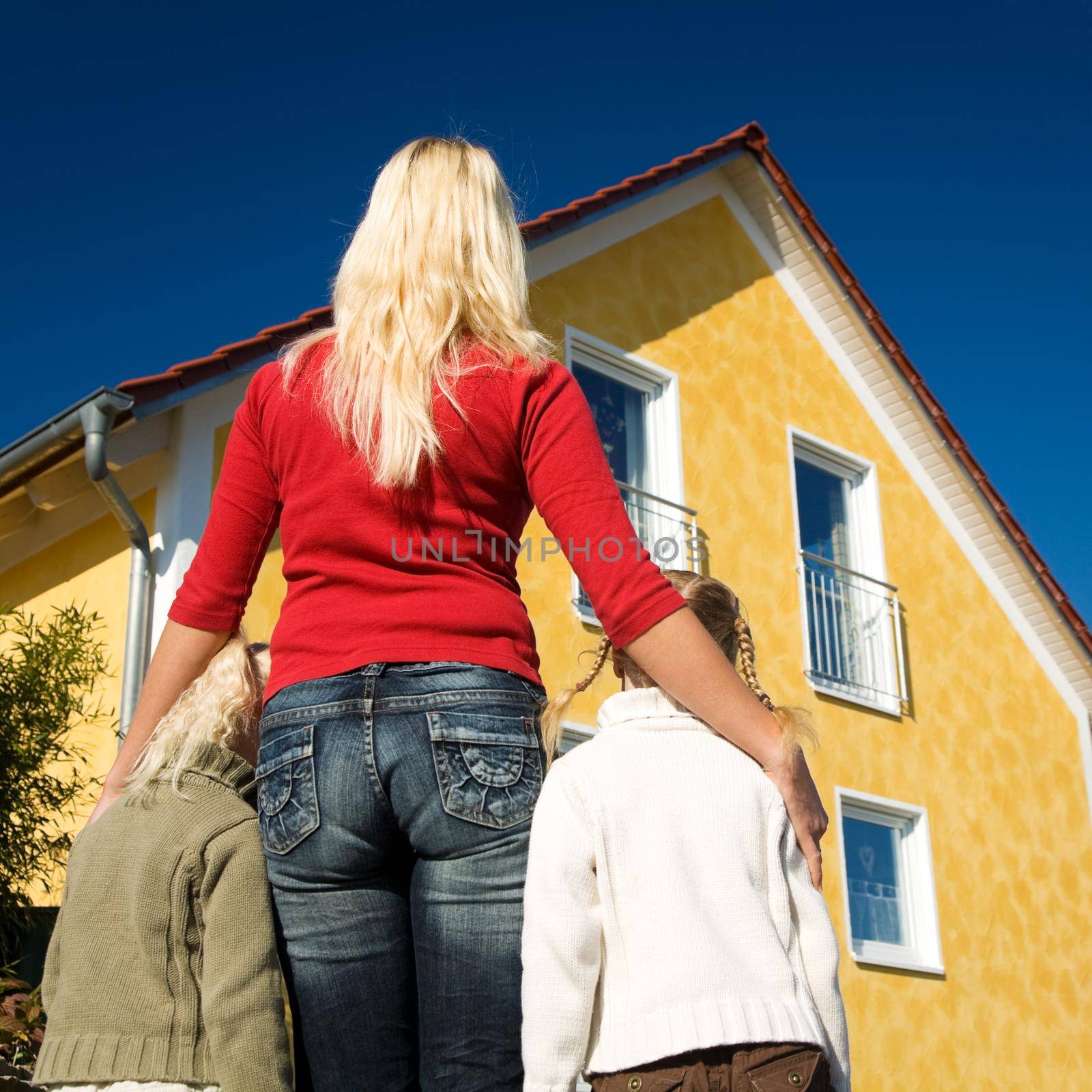 Mother and daughters dreaming of moving in a newly build home