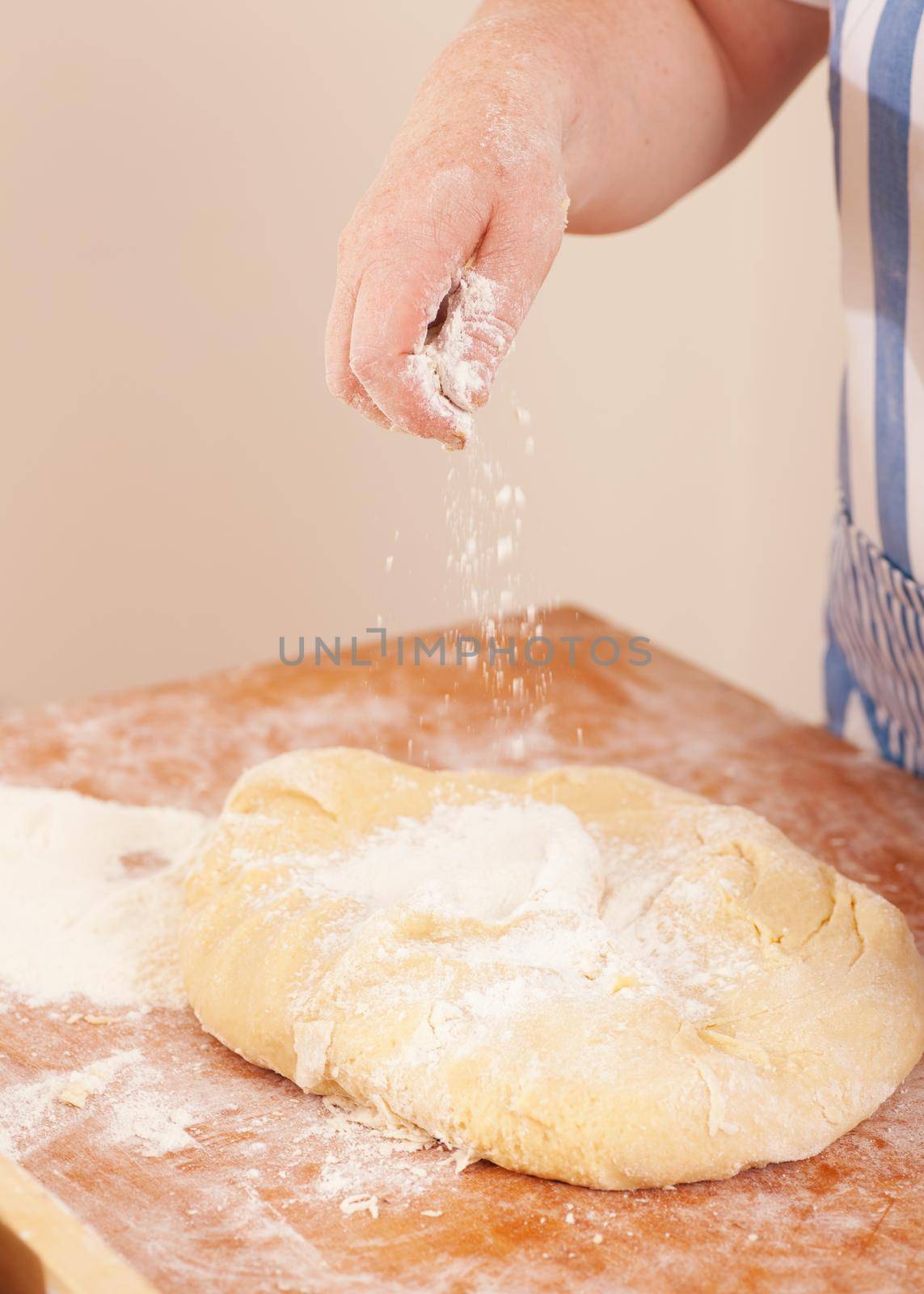 Baking biscuits, woman kneading the dough