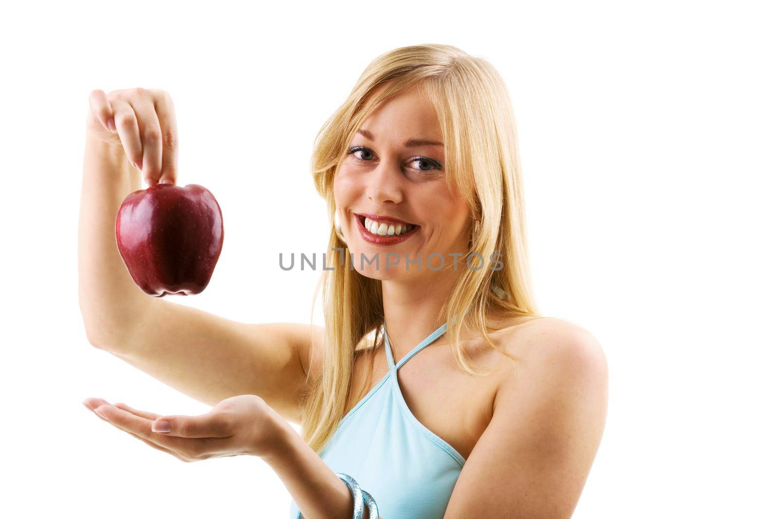 Food, fruit and healthy nutrition - Young blond woman holding an apple from above