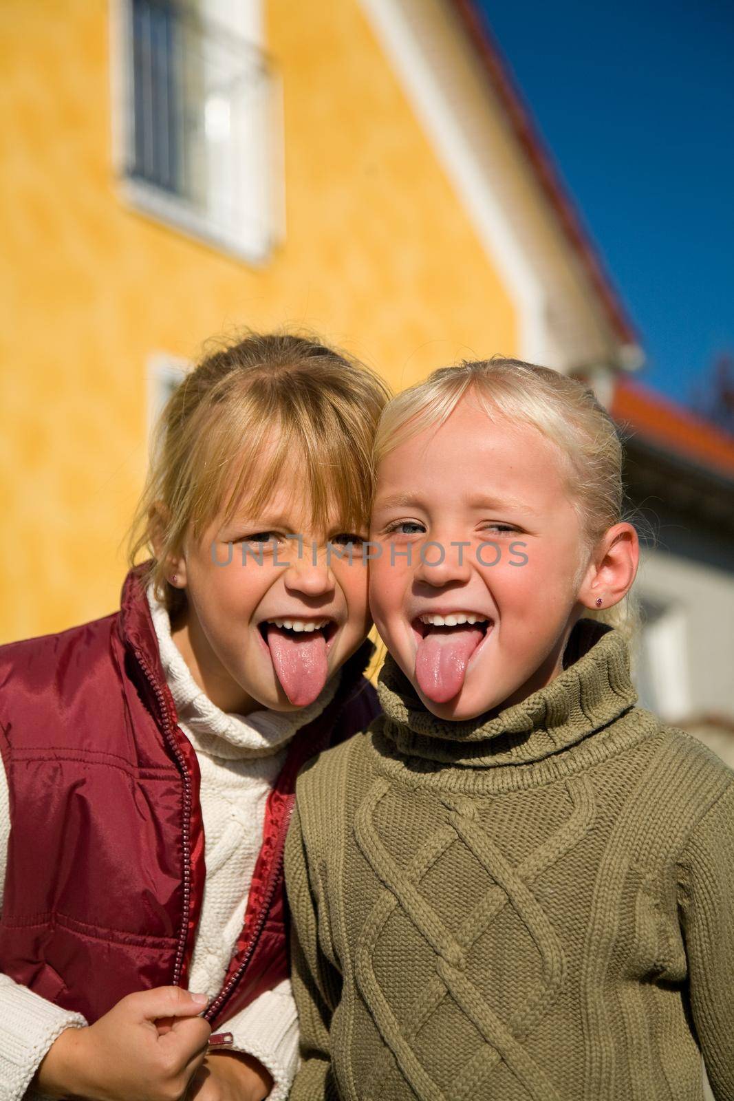 Sisters sticking their tongue out at the viewer