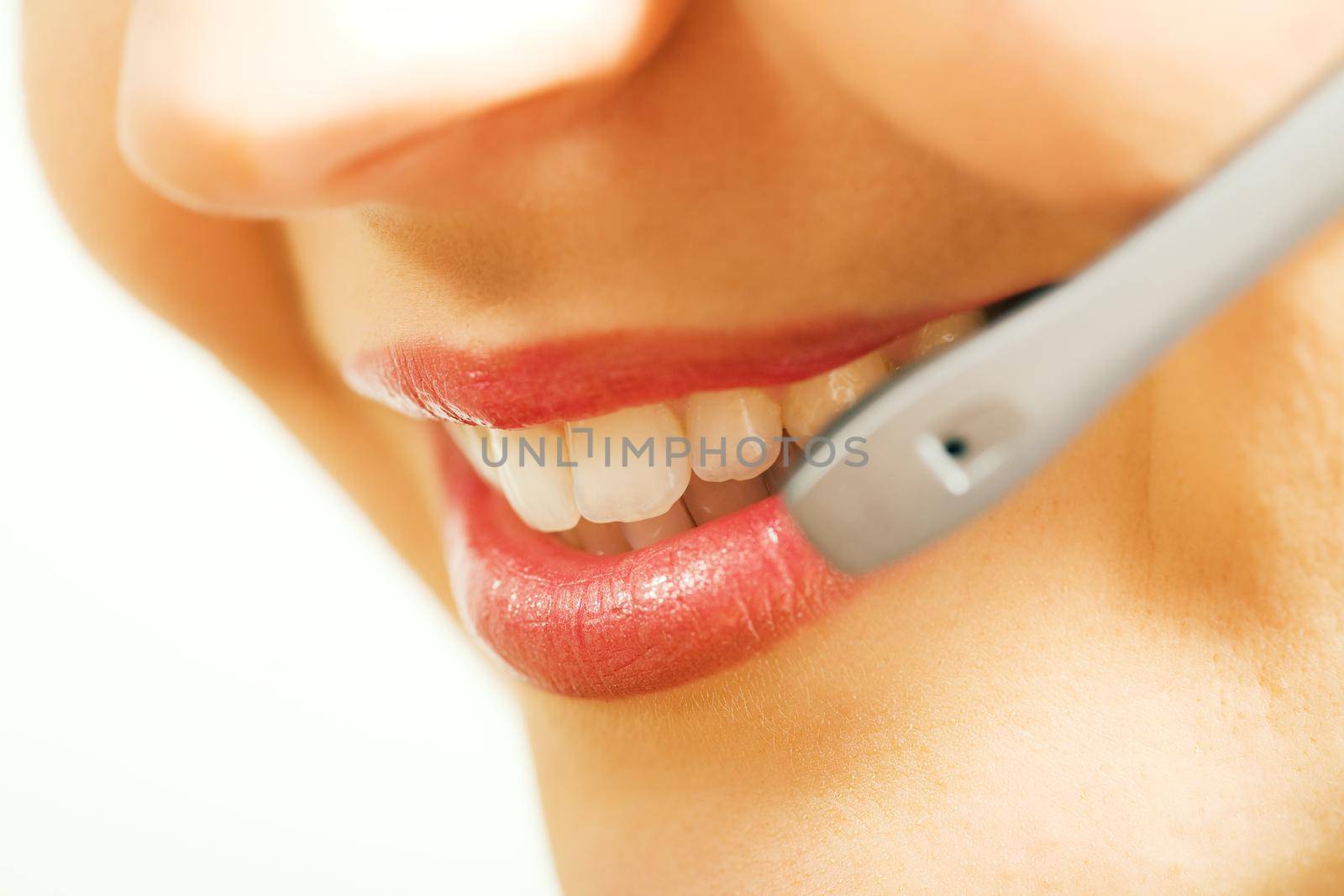 Close-up (mouth) of a friendly female call center operator