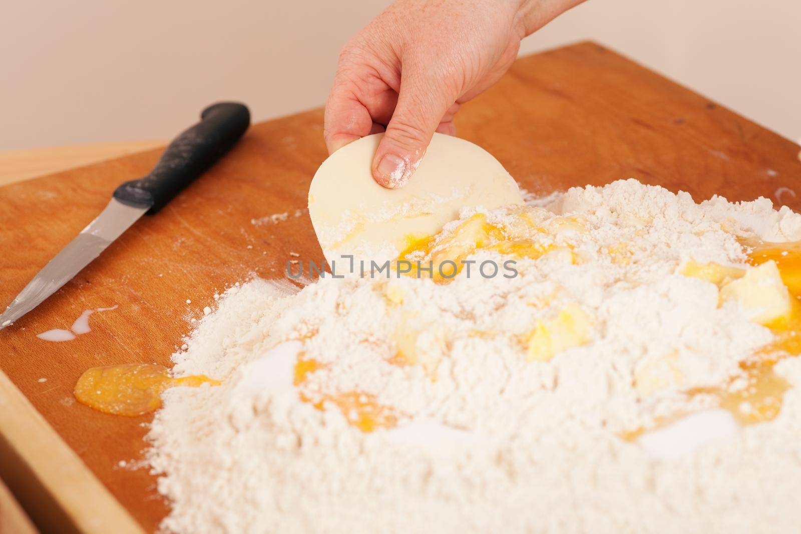 Baking biscuits - Woman mixes dough by Kzenon